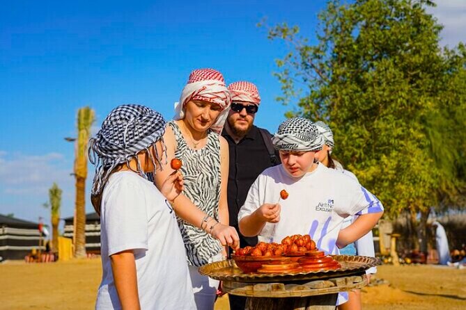 Desert Safari Dubai 30 Mins Quad Bike, Sand Board, Camel Ride BBQ - Live entertainment at camp: fire, Tanoura, belly dance, and more