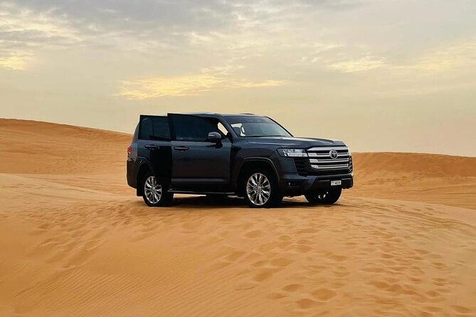 Doha: Desert Safari: Dune Bashing, Quad Bikes & Camel Rides - Stop 4 at the Tourist Point: sandboarding and dune bashing finale