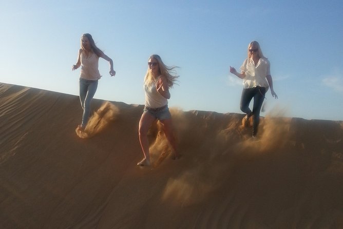 Dubai Desert Afternoon Quad Safari with Camel Ride, BBQ Dinner and Belly Dancing - Torchlit Bedouin camp: coffee, dates, henna, and sand art before dinner