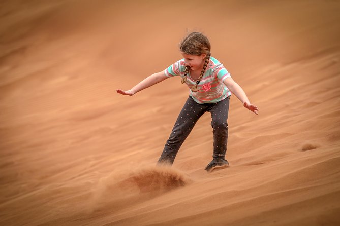 Dubai: Half-Day Desert Safari, Camels, Quad Bike & Refreshments - Sandboarding after the jeeps: playful, physical, and easy to try
