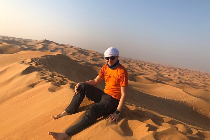 Dubai: Unique MORNING Quad Bike Red Dunes Safari - Sandboarding and the camel ride: two moods in one safari