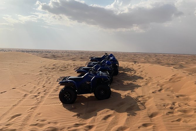Dubai: Unique SUNSET Quad Bike Red Dunes Safari - Desert camp BBQ dinner: food, shows, and henna
