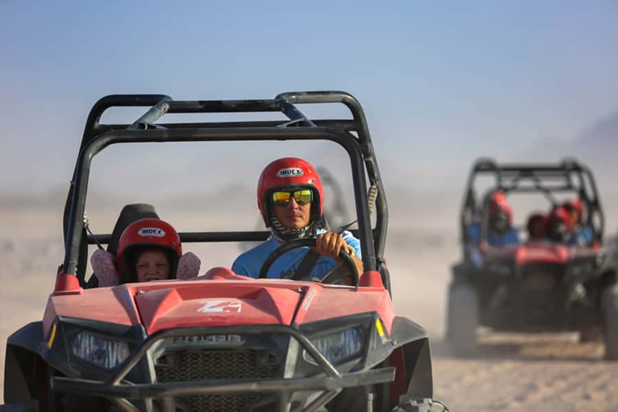 Hurghada: Sunset Desert Safari by Dune Buggy - Getting out of Hurghada: pickup, AC comfort, and village pass-bys