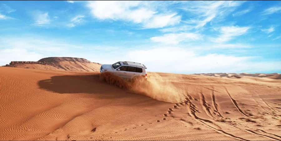 Quad Bike/Buggy, Desert Safari, Camel Ride, Dune Bashing - Sandboarding runs: fun on sand, not just a photo moment