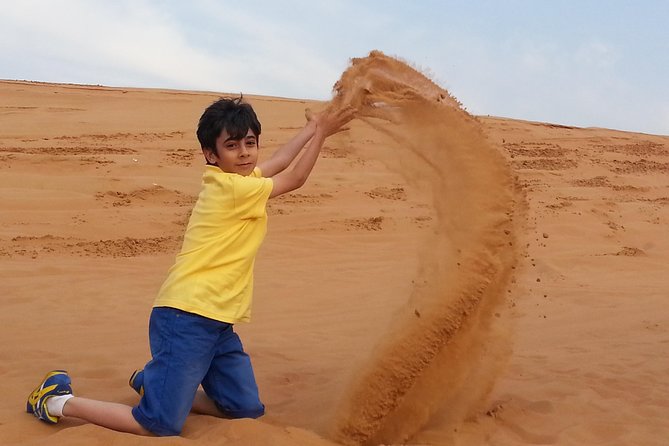 Red Dune Desert Safari & Quad Bike, BBQ Dinner. Camel Ride, Sandboarding - Sandboarding and camel riding: the best kind of contrast